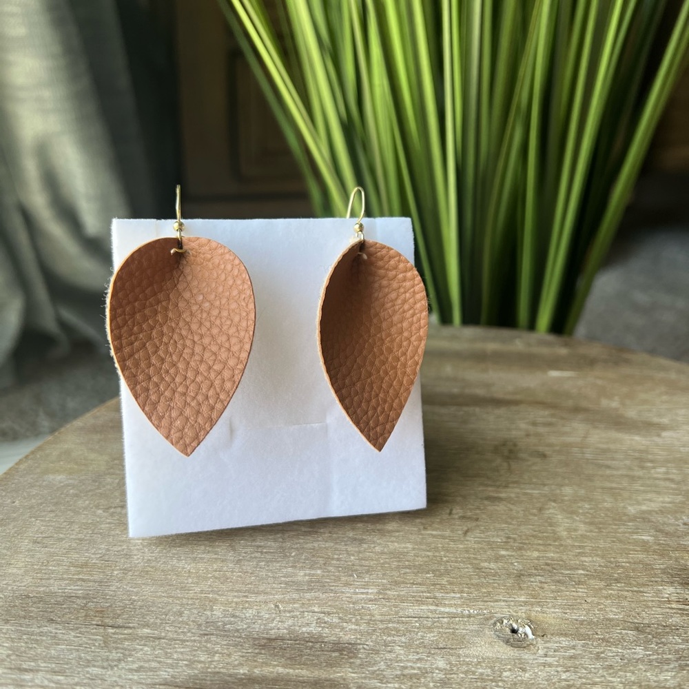 Brown faux leather earrings made by a local vendor. New, Never worn.